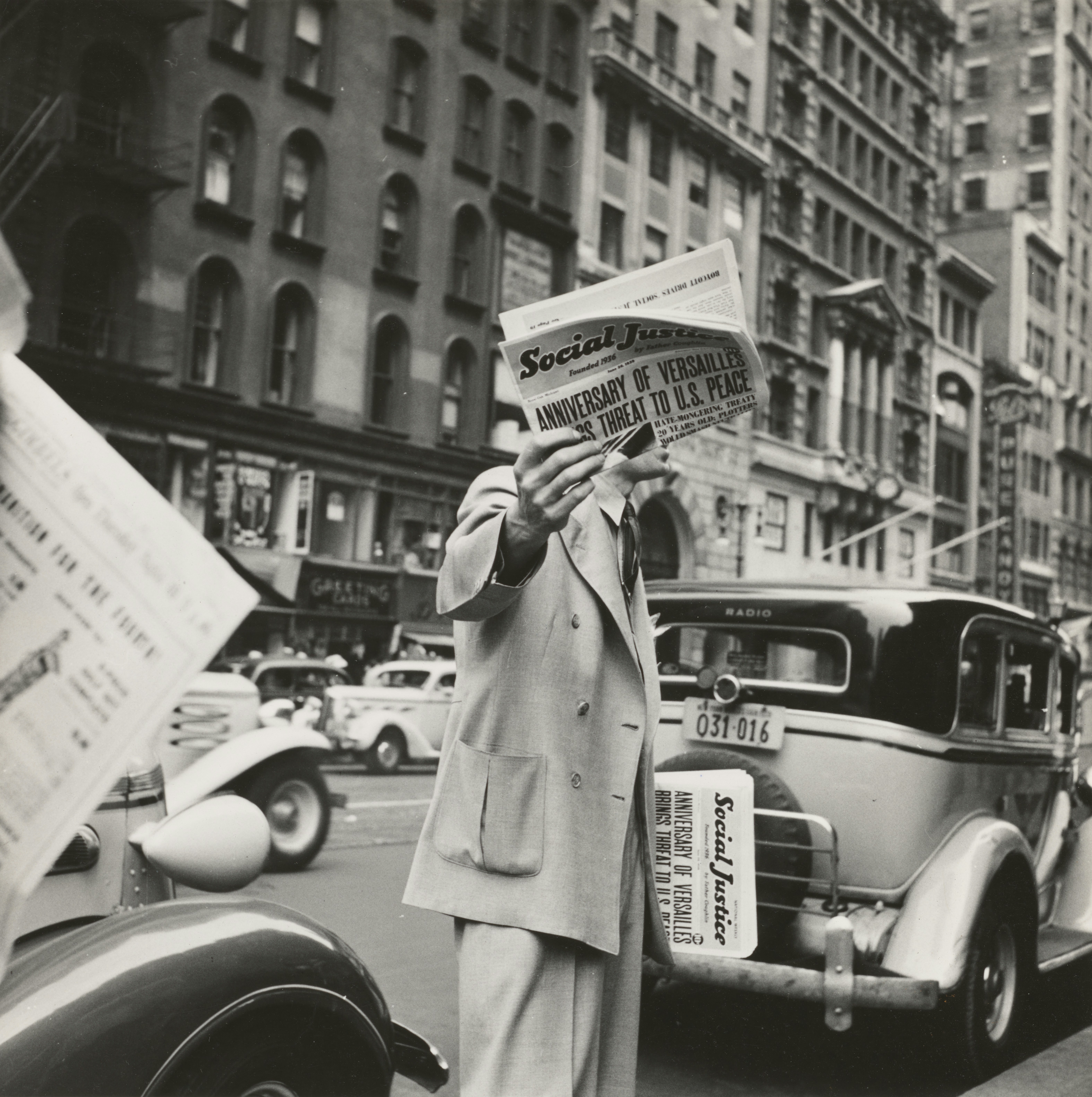 1939 - Social Justice, founded by Father Coughlin, sold on important street corners and intersections. New York City. Photographer - Dorothea Lange